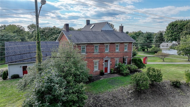 view of side of property with a lawn