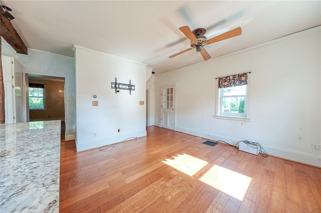 spare room with plenty of natural light, light hardwood / wood-style floors, and ceiling fan