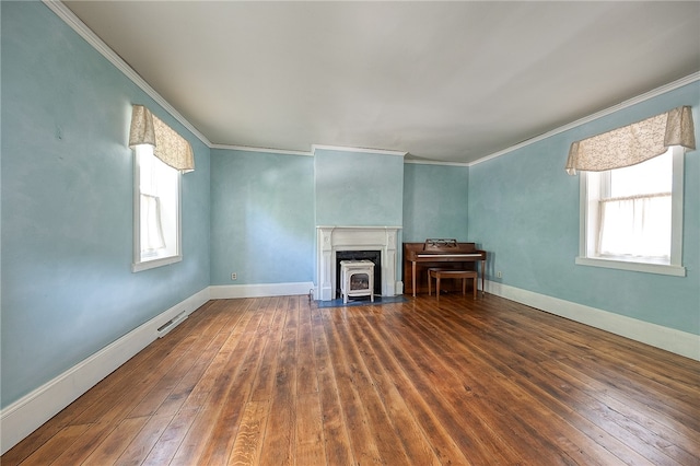 unfurnished living room featuring a wealth of natural light, crown molding, and dark hardwood / wood-style floors