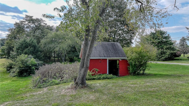 view of outbuilding featuring a yard