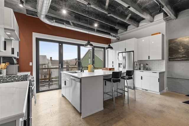 kitchen with decorative light fixtures, sink, white cabinetry, and stainless steel appliances