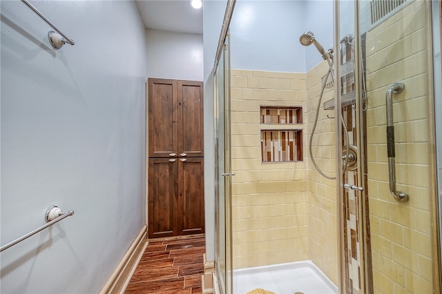 bathroom with wood-type flooring and walk in shower