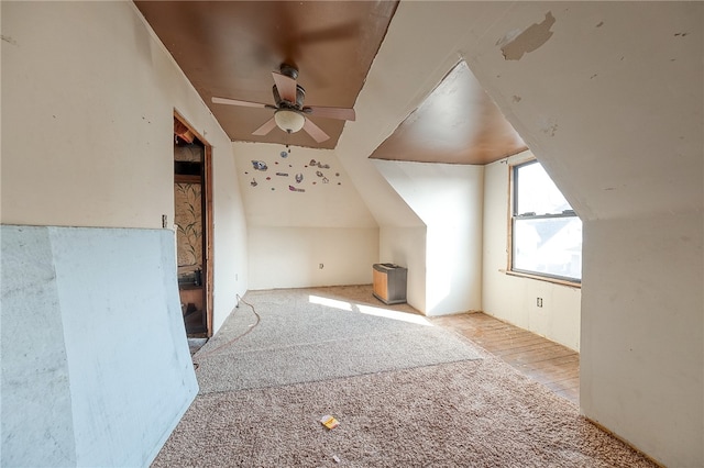 additional living space featuring ceiling fan, light hardwood / wood-style flooring, and vaulted ceiling