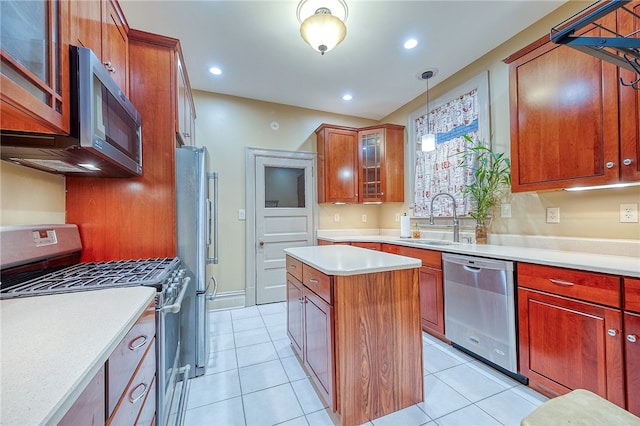 kitchen with sink, a kitchen island, decorative light fixtures, light tile patterned floors, and appliances with stainless steel finishes