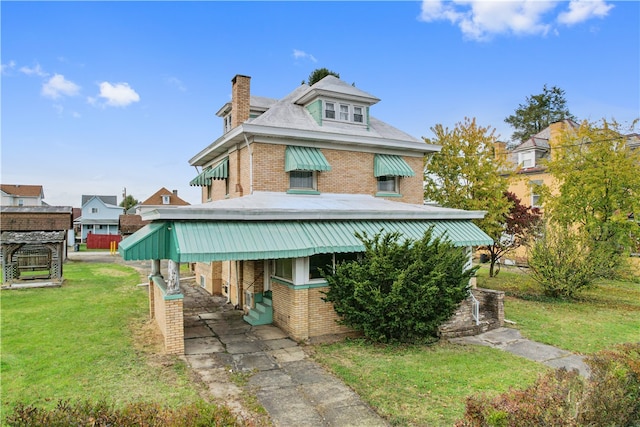 back of house with a carport and a lawn