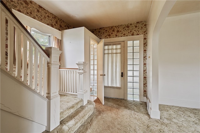 entryway with light colored carpet