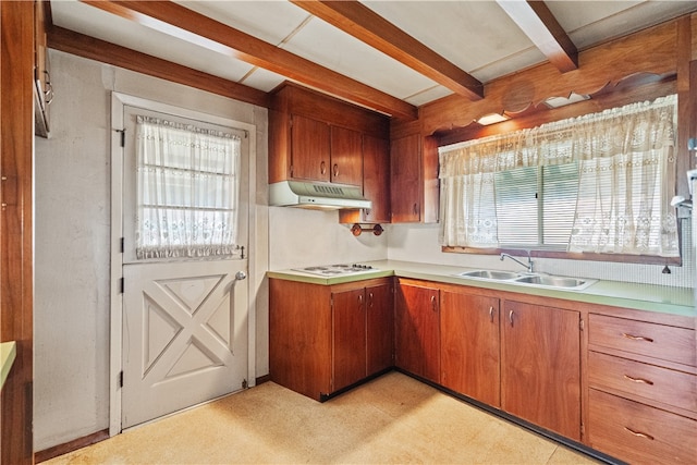 kitchen with beam ceiling, white gas cooktop, and sink