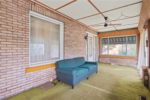 sunroom featuring ceiling fan