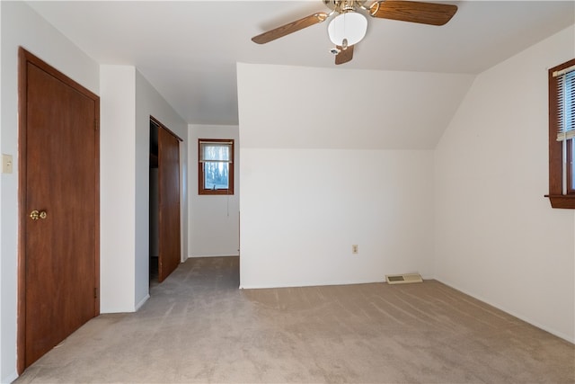 bonus room with light carpet, ceiling fan, and lofted ceiling