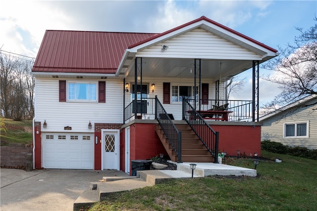 view of front facade with a porch, a garage, and a front lawn