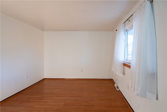 spare room featuring hardwood / wood-style floors