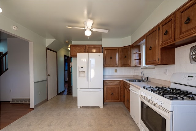 kitchen featuring backsplash, light hardwood / wood-style floors, white appliances, and sink