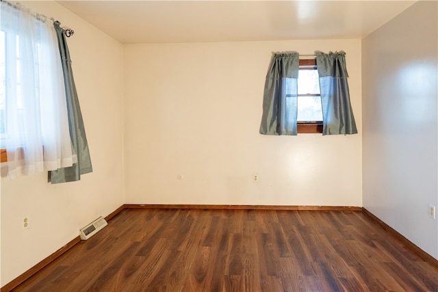 spare room featuring dark wood-type flooring