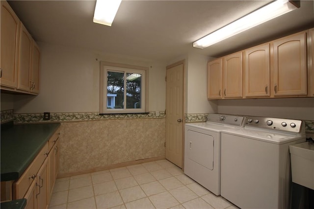 laundry room with washer and dryer, light tile patterned flooring, cabinets, and sink