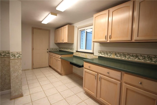 kitchen featuring light brown cabinetry and light tile patterned flooring