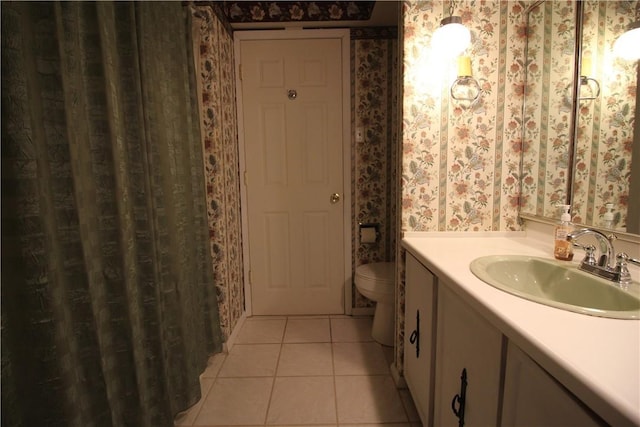 bathroom featuring toilet, vanity, and tile patterned floors