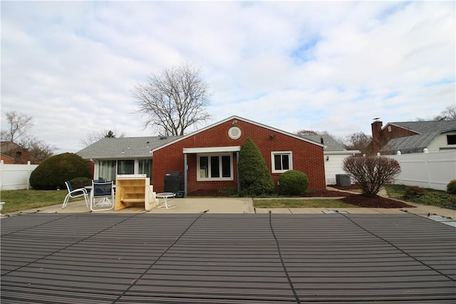 rear view of property featuring a patio and cooling unit