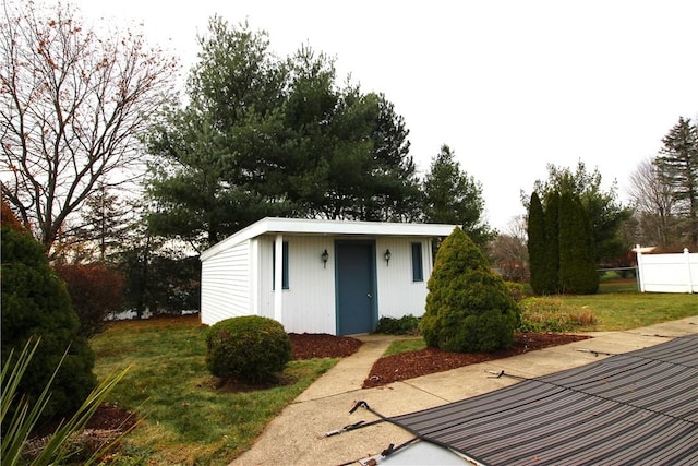 view of outbuilding with a yard