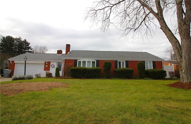 ranch-style house featuring a garage and a front lawn