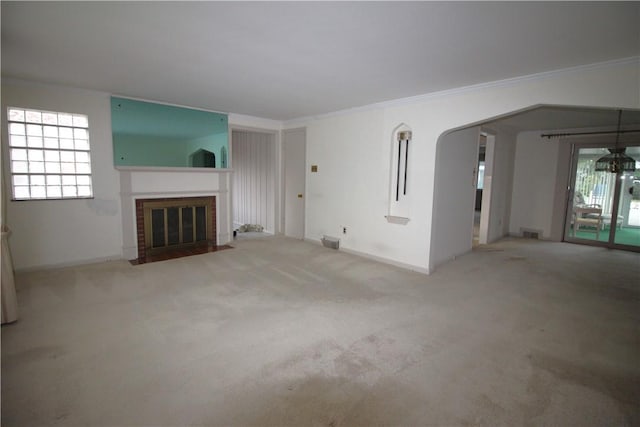 unfurnished living room featuring crown molding and light colored carpet