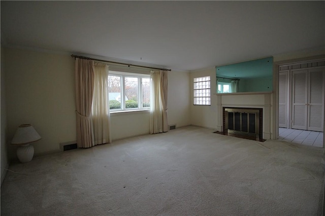 unfurnished living room featuring light colored carpet and ornamental molding