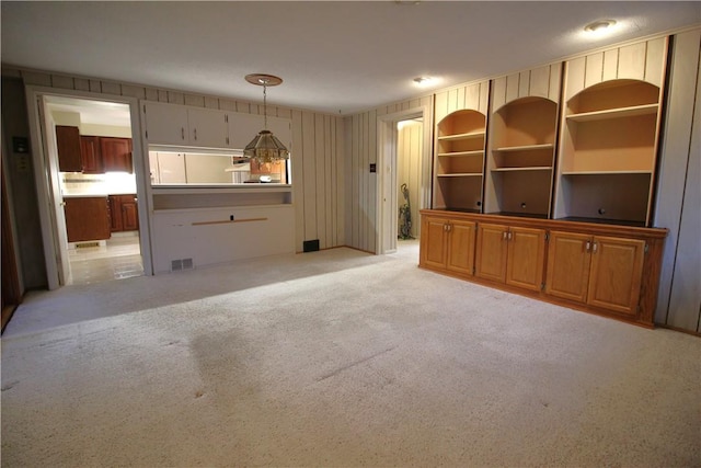 unfurnished living room with light carpet