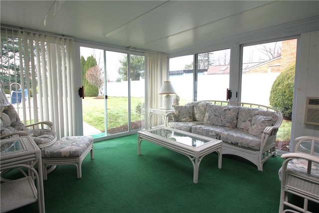 sunroom featuring a water view and a healthy amount of sunlight