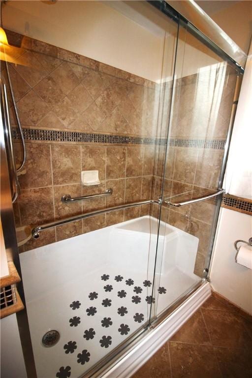 bathroom featuring tile patterned floors and a shower with door