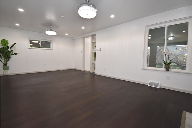 unfurnished room featuring dark hardwood / wood-style flooring