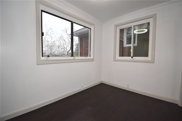 unfurnished room featuring dark hardwood / wood-style floors and ornamental molding