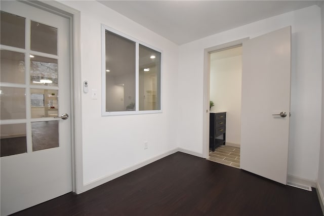 unfurnished room featuring dark wood-type flooring