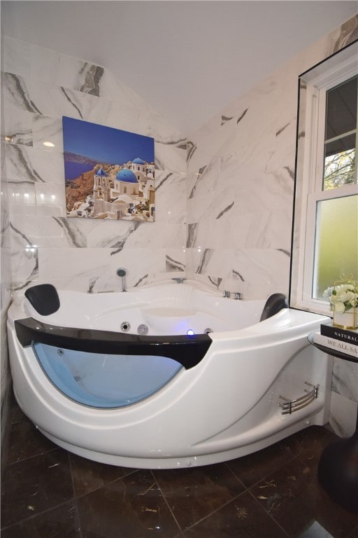 bathroom featuring a bathing tub and tile walls