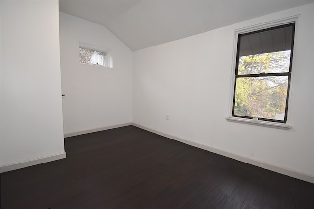 unfurnished room with vaulted ceiling and dark hardwood / wood-style floors