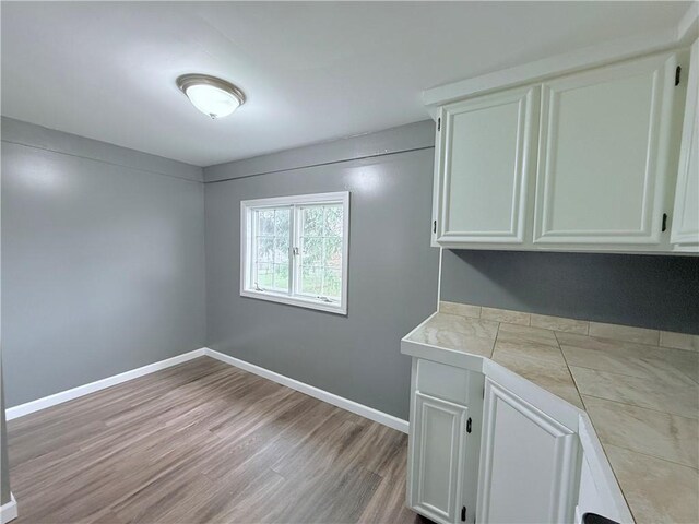 laundry room with light wood-type flooring