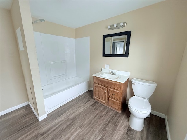 full bathroom featuring hardwood / wood-style floors, vanity, toilet, and tub / shower combination