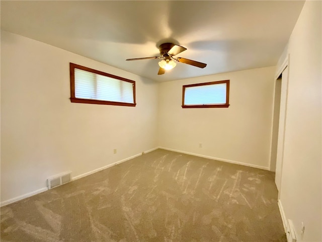 carpeted empty room with ceiling fan