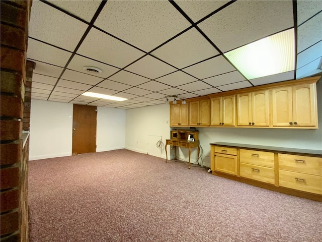 basement featuring carpet flooring and a drop ceiling