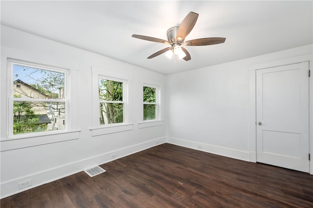 spare room featuring ceiling fan and dark hardwood / wood-style flooring