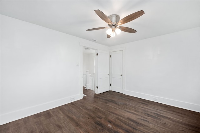 spare room with ceiling fan and dark hardwood / wood-style flooring