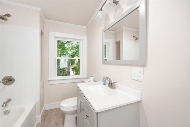 full bathroom with bathtub / shower combination, vanity, crown molding, wood-type flooring, and toilet