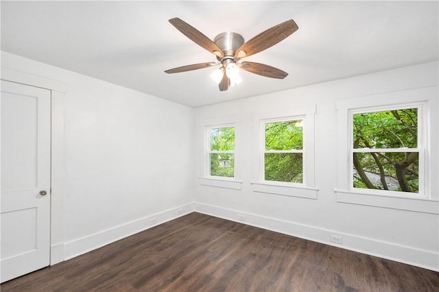 spare room with ceiling fan and dark wood-type flooring