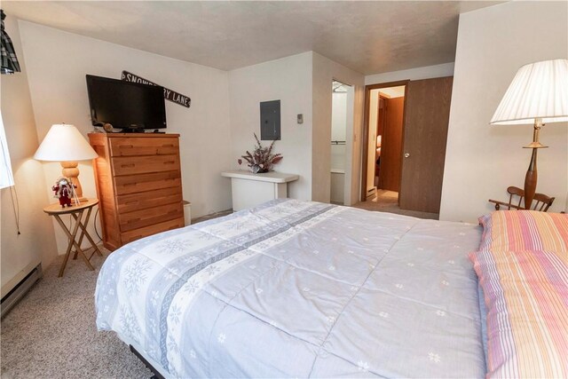 bedroom with light colored carpet, electric panel, and a baseboard heating unit