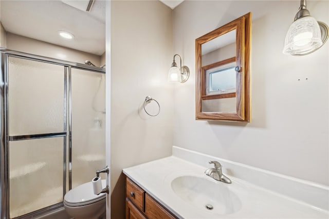 bathroom featuring vanity, toilet, and an enclosed shower