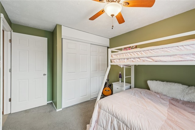 carpeted bedroom featuring a closet and ceiling fan