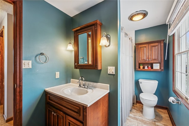 bathroom with vanity, toilet, and plenty of natural light