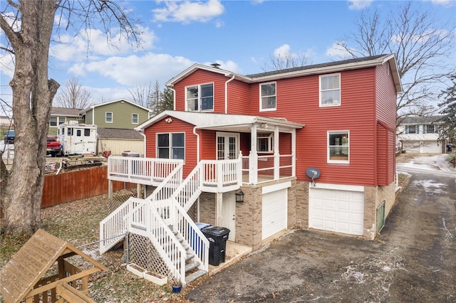 back of house with a porch and a garage