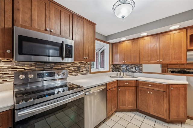 kitchen with light tile patterned flooring, appliances with stainless steel finishes, tasteful backsplash, and sink