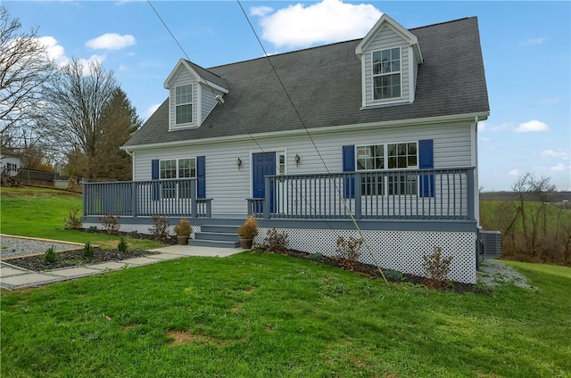 cape cod house featuring a front yard and central AC unit