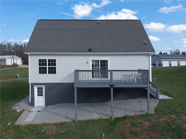 back of property featuring a wooden deck and a yard