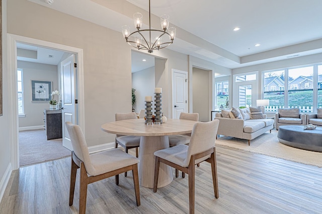 dining room featuring light hardwood / wood-style flooring and a notable chandelier